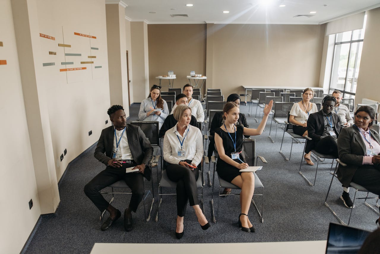 A group of diverse adults attending a business meeting in a modern conference room.
